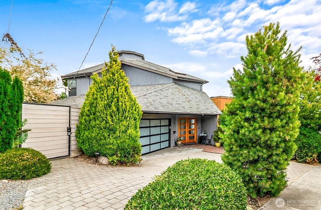 3406 SW Manning St, Seattle, WA 98126 - view of front of house with a garage and a shingled roof