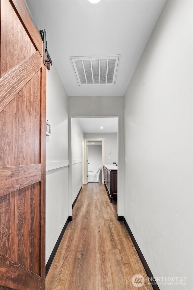19621 N Glade Rd, Mesa, WA 99343 - corridor with light wood-type flooring and a barn door