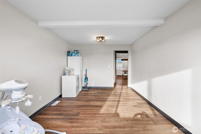 19621 N Glade Rd, Mesa, WA 99343 - bedroom with beam ceiling, wood finished floors, and freestanding refrigerator