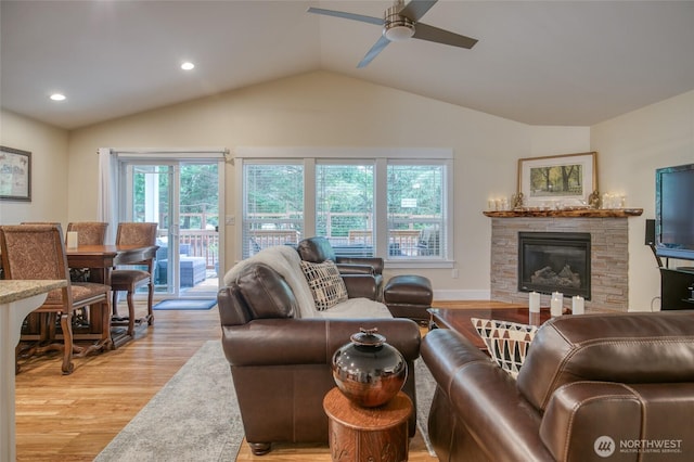 789 Island Cir SE, Ocean Shores, WA 98569 - living room with light wood-style floors, a ceiling fan, a stone fireplace, vaulted ceiling, and recessed lighting
