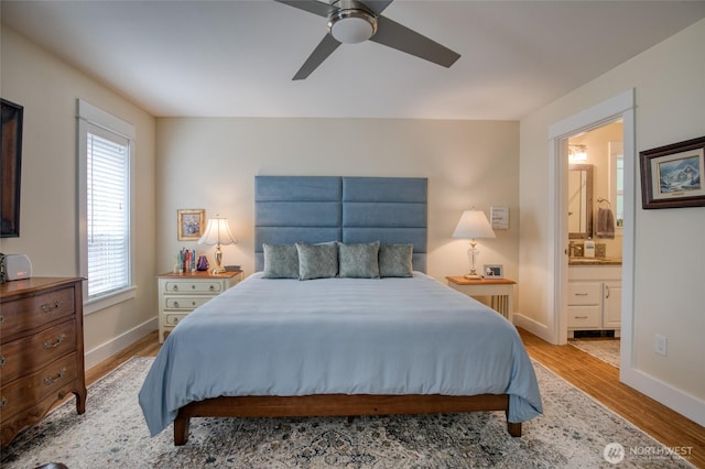 789 Island Cir SE, Ocean Shores, WA 98569 - bedroom featuring wood finished floors, ensuite bath, and ceiling fan