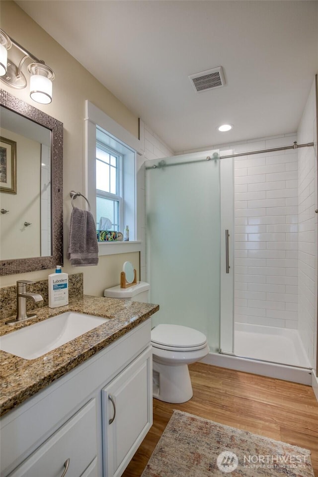 789 Island Cir SE, Ocean Shores, WA 98569 - bathroom featuring vanity, a shower stall, wood finished floors, and recessed lighting