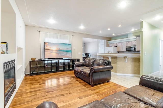 9460 Albert Way SE, Moses Lake, WA 98837 - living room with a glass covered fireplace, light wood finished floors, and recessed lighting