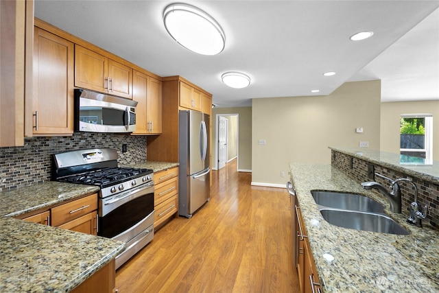 22526 87th Pl W, Edmonds, WA 98026 - kitchen featuring appliances with stainless steel finishes, backsplash, light wood-style floors, light stone counters, and recessed lighting