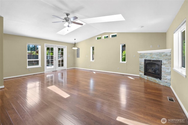 22526 87th Pl W, Edmonds, WA 98026 - unfurnished living room featuring vaulted ceiling, a skylight, plenty of natural light, and wood finished floors