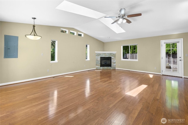 22526 87th Pl W, Edmonds, WA 98026 - unfurnished living room featuring electric panel, a skylight, ceiling fan, lofted ceiling, and wood finished floors