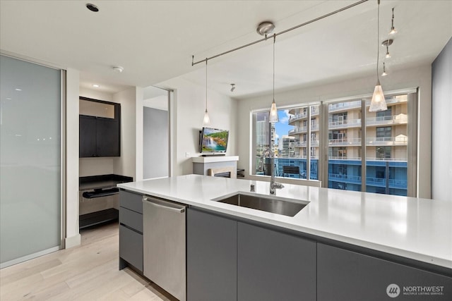 737 Olive Way Unit 1903, Seattle, WA 98101 - kitchen featuring stainless steel dishwasher, gray cabinets, light wood-type flooring, and light countertops