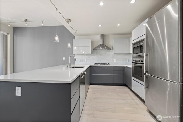 737 Olive Way Unit 1903, Seattle, WA 98101 - kitchen featuring stainless steel appliances, wall chimney range hood, modern cabinets, gray cabinets, and a peninsula