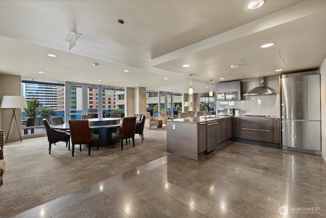 737 Olive Way Unit 1903, Seattle, WA 98101 - kitchen featuring wall chimney range hood, modern cabinets, stainless steel appliances, french doors, and open floor plan