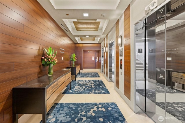 737 Olive Way Unit 1903, Seattle, WA 98101 - corridor featuring a tray ceiling, wood walls, light tile patterned flooring, and elevator