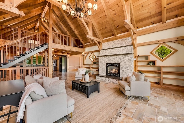991 Lakeview St, Bellingham, WA 98229 - living area with a wooden ceiling with exposed beams, stairway, a chandelier, a tiled fireplace, and stone finish flooring