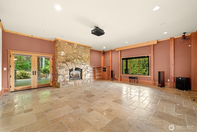 991 Lakeview St, Bellingham, WA 98229 - unfurnished living room with stone tile floors, healthy amount of natural light, a stone fireplace, french doors, and recessed lighting