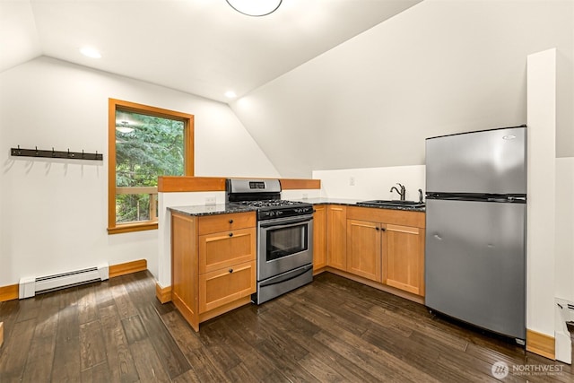 991 Lakeview St, Bellingham, WA 98229 - kitchen featuring appliances with stainless steel finishes, a baseboard radiator, lofted ceiling, dark stone countertops, and a peninsula