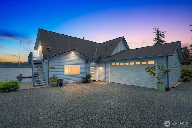 5341 S Bercot Rd, Freeland, WA 98249 - view of front of property featuring an attached garage, stairs, roof with shingles, and gravel driveway