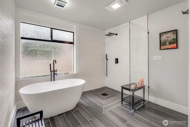 5341 S Bercot Rd, Freeland, WA 98249 - full bathroom featuring a soaking tub, a walk in shower, plenty of natural light, and wood finish floors