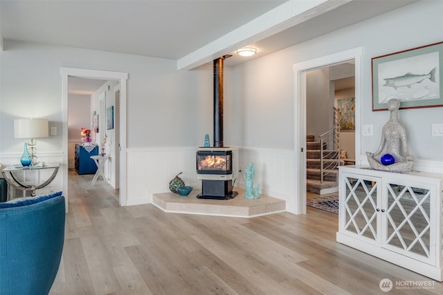 5341 S Bercot Rd, Freeland, WA 98249 - living room with a wood stove, a wainscoted wall, wood finished floors, and stairs
