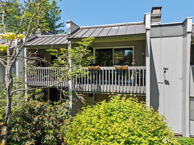 7501 Ruby Dr SW Unit G202, Lakewood, WA 98498 - rear view of property with a standing seam roof, a metal roof, and a chimney