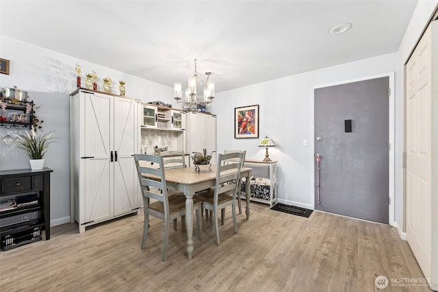 7501 Ruby Dr SW Unit G202, Lakewood, WA 98498 - dining space featuring a chandelier and light wood-style flooring