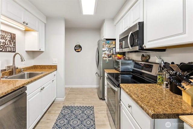 7501 Ruby Dr SW Unit G202, Lakewood, WA 98498 - kitchen featuring stainless steel appliances, light wood-style floors, and white cabinetry