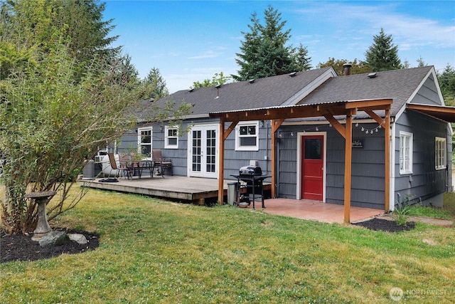 5140 Johnson Point Rd NE, Olympia, WA 98516 - back of property featuring a deck, a yard, french doors, and a shingled roof