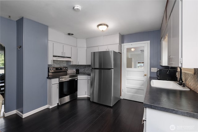 5140 Johnson Point Rd NE, Olympia, WA 98516 - kitchen featuring appliances with stainless steel finishes, dark countertops, decorative backsplash, and under cabinet range hood