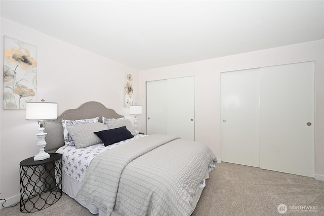10263 NE 129th Ln, Kirkland, WA 98034 - carpeted bedroom featuring two closets and baseboards
