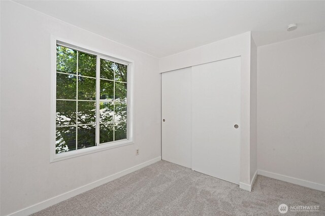 10263 NE 129th Ln, Kirkland, WA 98034 - unfurnished bedroom featuring light colored carpet and a closet
