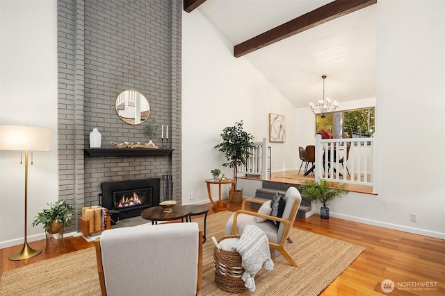 6687 NE Bayview Blvd, Bainbridge Island, WA 98110 - living area featuring wood finished floors, beam ceiling, a fireplace, high vaulted ceiling, and a chandelier