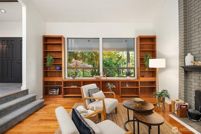 6687 NE Bayview Blvd, Bainbridge Island, WA 98110 - living area featuring wood finished floors, a fireplace, and stairs