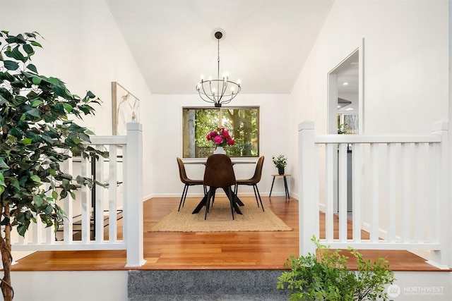 6687 NE Bayview Blvd, Bainbridge Island, WA 98110 - dining space featuring lofted ceiling, a chandelier, and wood finished floors