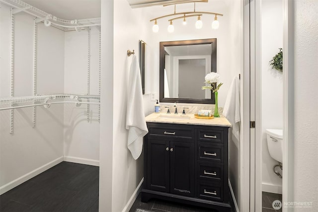 6687 NE Bayview Blvd, Bainbridge Island, WA 98110 - bathroom with vanity, a spacious closet, and wood finished floors