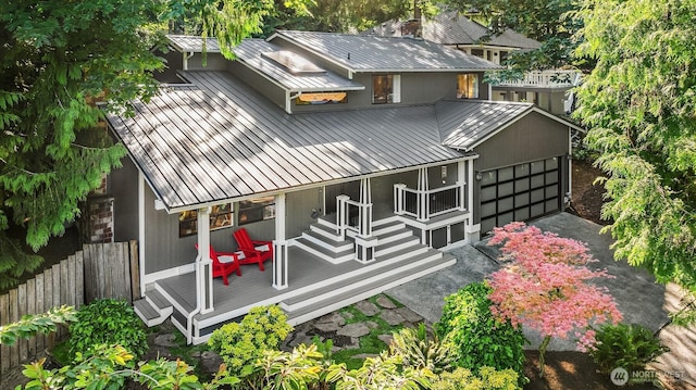 6687 NE Bayview Blvd, Bainbridge Island, WA 98110 - back of property with a metal roof, a standing seam roof, a garage, a wooden deck, and asphalt driveway