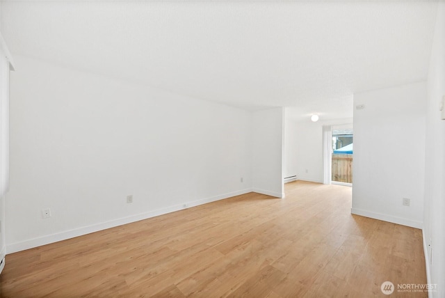 6610 S Madison St, Tacoma, WA 98409 - unfurnished room featuring baseboard heating and light wood-type flooring