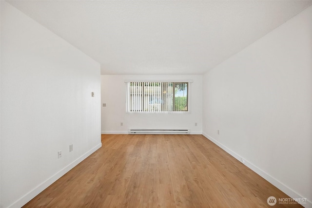 6610 S Madison St, Tacoma, WA 98409 - spare room featuring baseboard heating and light wood finished floors