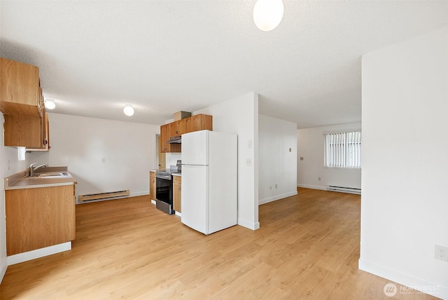 6610 S Madison St, Tacoma, WA 98409 - kitchen featuring freestanding refrigerator, stainless steel electric range oven, a baseboard heating unit, under cabinet range hood, and light wood-style flooring
