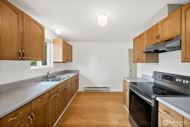 6610 S Madison St, Tacoma, WA 98409 - kitchen with electric range, under cabinet range hood, baseboard heating, light wood-style flooring, and a textured ceiling