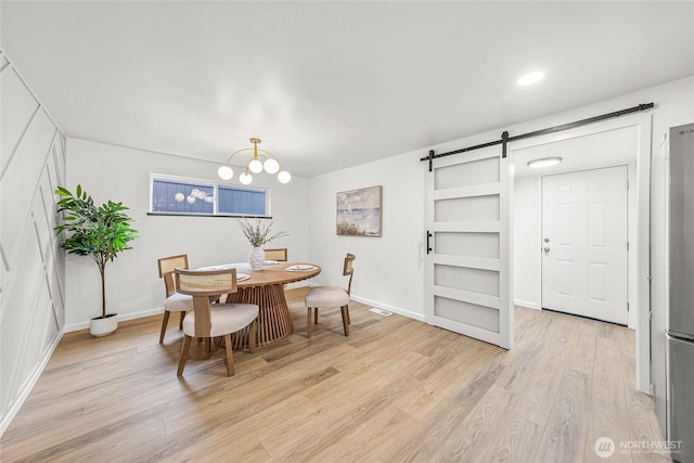 8808 NE 139th St, Kirkland, WA 98034 - dining room featuring a barn door, light wood-style flooring, and a chandelier