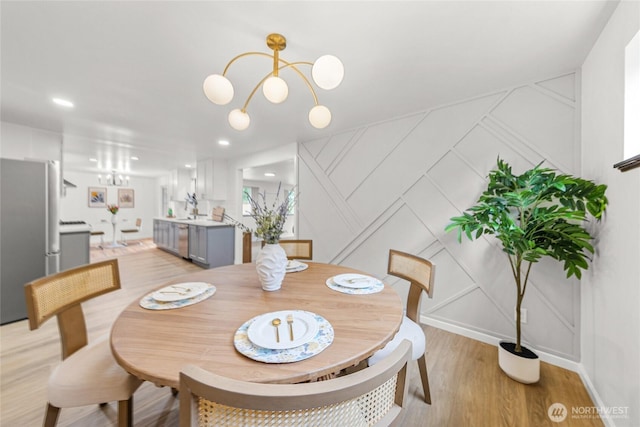 8808 NE 139th St, Kirkland, WA 98034 - dining space featuring a decorative wall, a chandelier, light wood-style flooring, and recessed lighting