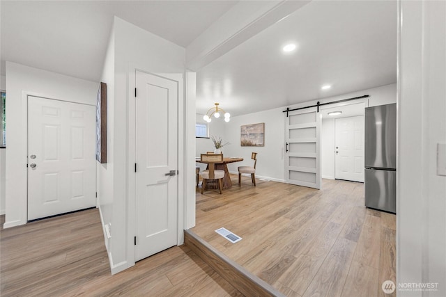 8808 NE 139th St, Kirkland, WA 98034 - entrance foyer featuring a barn door, light wood-style floors, and recessed lighting