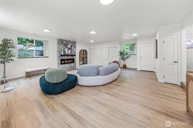 8808 NE 139th St, Kirkland, WA 98034 - living area with plenty of natural light, a high end fireplace, light wood finished floors, and recessed lighting