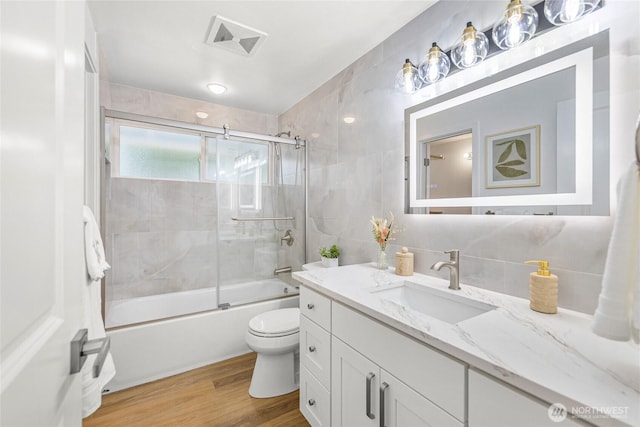 8808 NE 139th St, Kirkland, WA 98034 - full bathroom featuring vanity, wood finished floors, and bath / shower combo with glass door