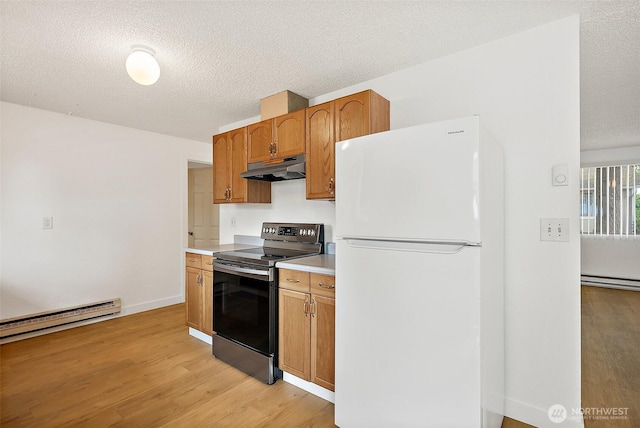 6604 S Madison St, Tacoma, WA 98409 - kitchen with freestanding refrigerator, stainless steel range with electric stovetop, under cabinet range hood, a baseboard heating unit, and light wood finished floors