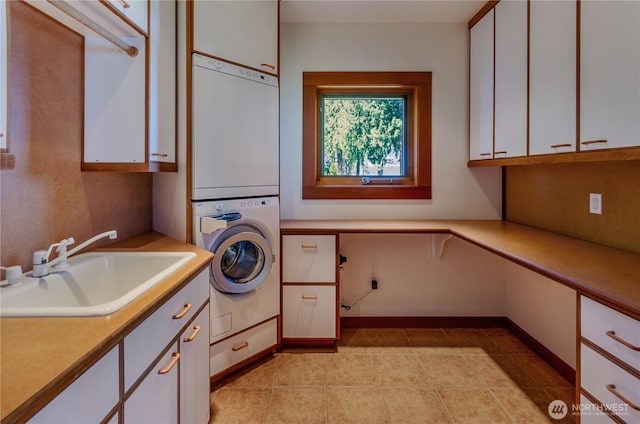 9913 Point View St NE, Olympia, WA 98516 - laundry area with cabinet space, stacked washer and clothes dryer, and light tile patterned floors