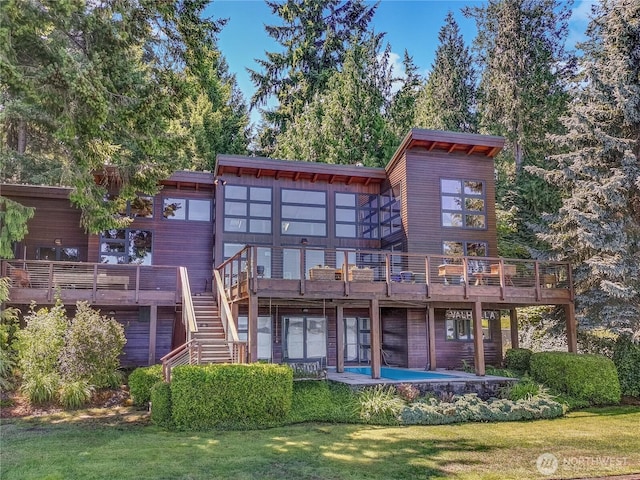 9913 Point View St NE, Olympia, WA 98516 - back of property featuring a wooden deck, a yard, a patio, and stairway