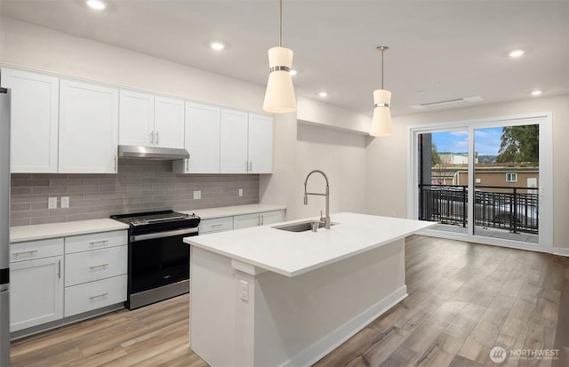 6901 NE 184th Ln Unit 103, Kenmore, WA 98028 - kitchen featuring stainless steel range with electric cooktop, under cabinet range hood, decorative backsplash, light wood-style flooring, and light countertops