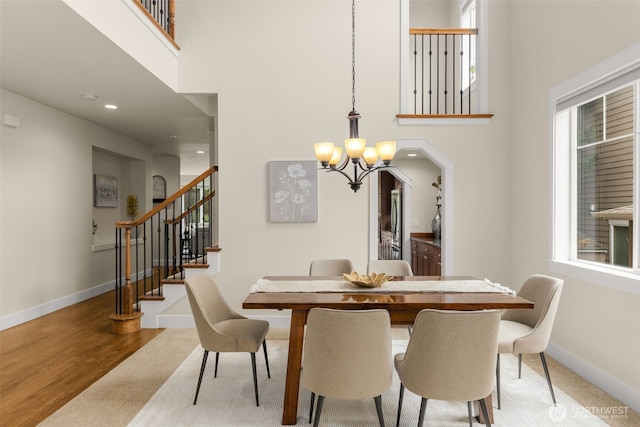 3414 SE 223rd Ave, Sammamish, WA 98075 - dining area featuring a chandelier, a towering ceiling, stairs, carpet, and recessed lighting