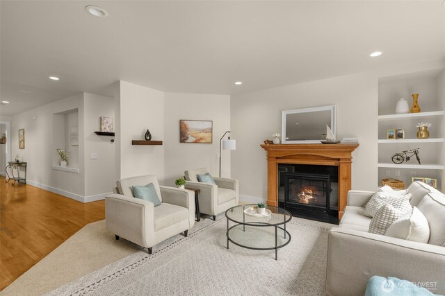 3414 SE 223rd Ave, Sammamish, WA 98075 - living room featuring recessed lighting, a fireplace with flush hearth, wood finished floors, and built in shelves