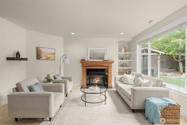 3414 SE 223rd Ave, Sammamish, WA 98075 - living room featuring a glass covered fireplace, recessed lighting, and built in shelves