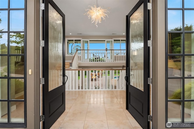 9620 NE 28th St, Clyde Hill, WA 98004 - doorway with light tile patterned flooring and a chandelier