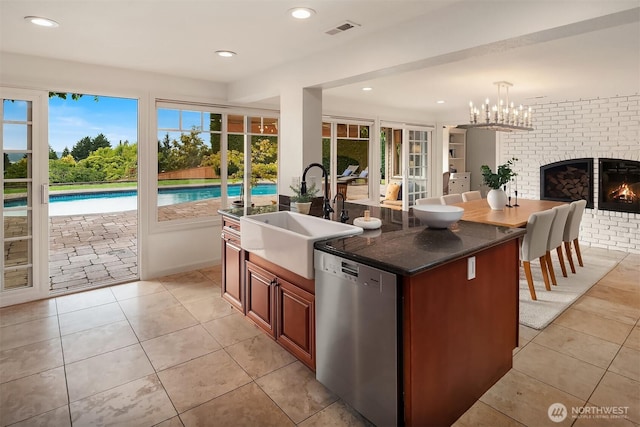 9620 NE 28th St, Clyde Hill, WA 98004 - kitchen with stainless steel dishwasher, a fireplace, open floor plan, an island with sink, and light tile patterned floors